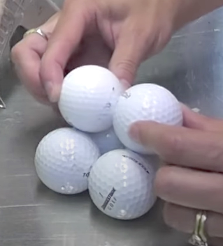 Glue two golf balls on top of the four golf balls