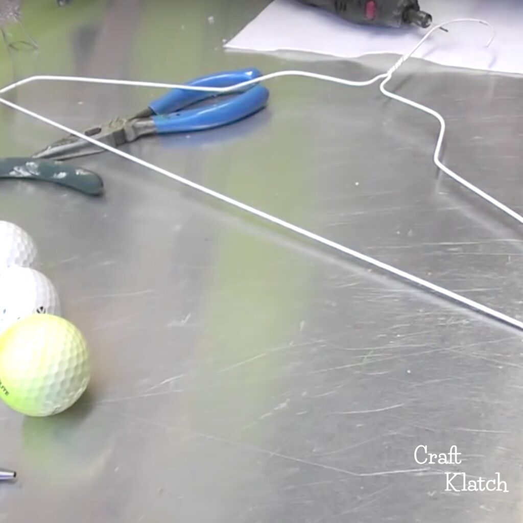 Wire hanger with golf balls - recycled materials for project