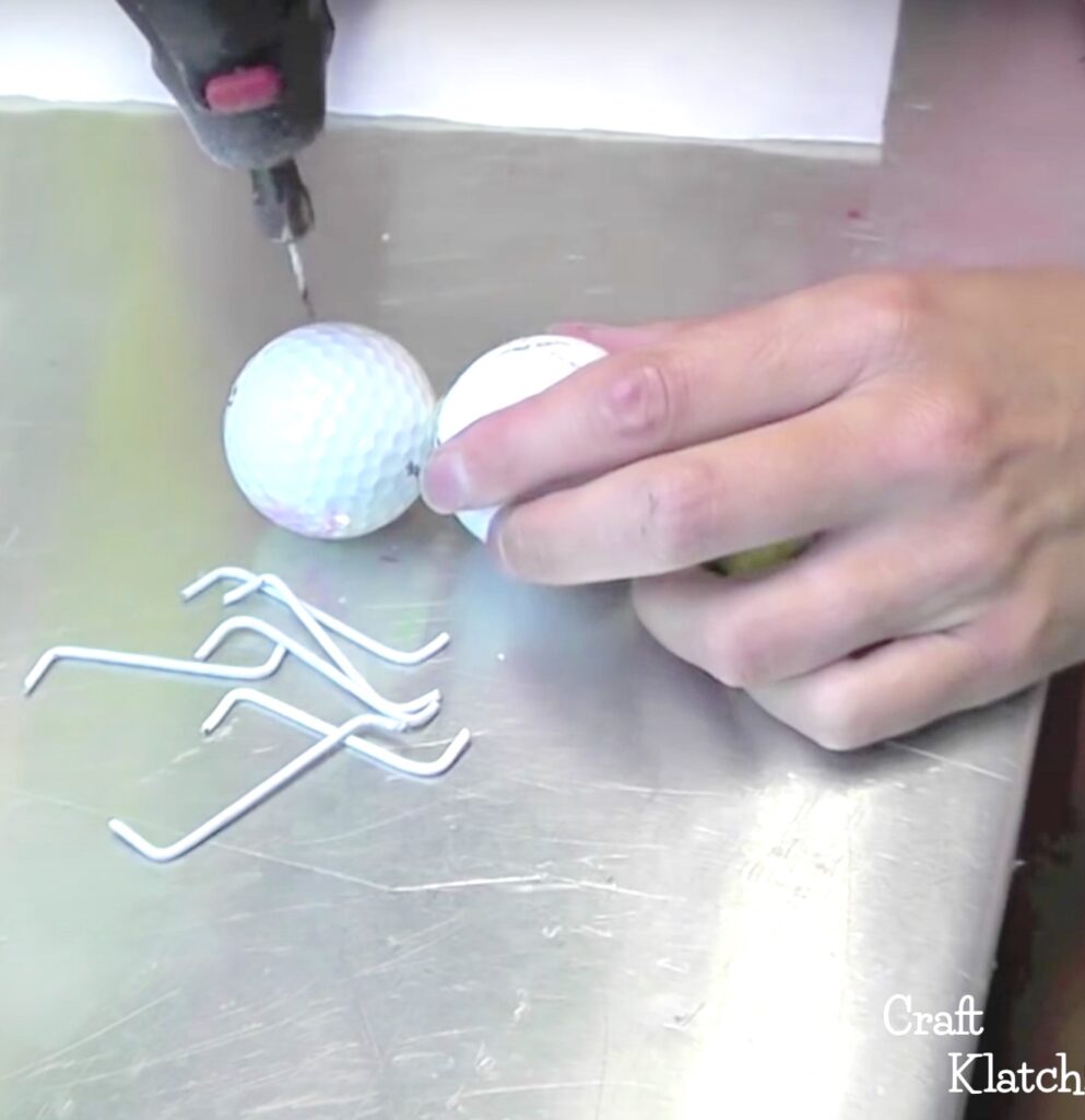 Drilling hole into golf ball for ant legs