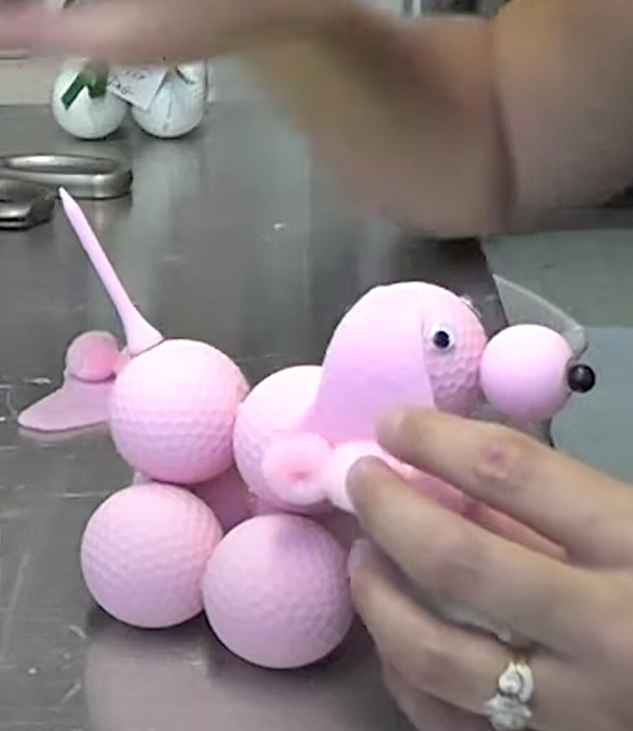 Glue on ears to the pink poodle