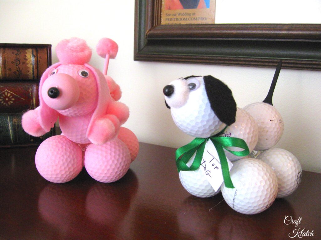 Pink golf ball poodle and white golf ball dog