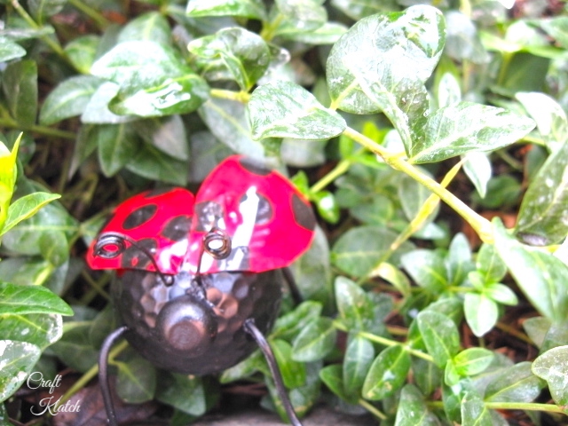 Ladybug made from recycled items in green ground cover