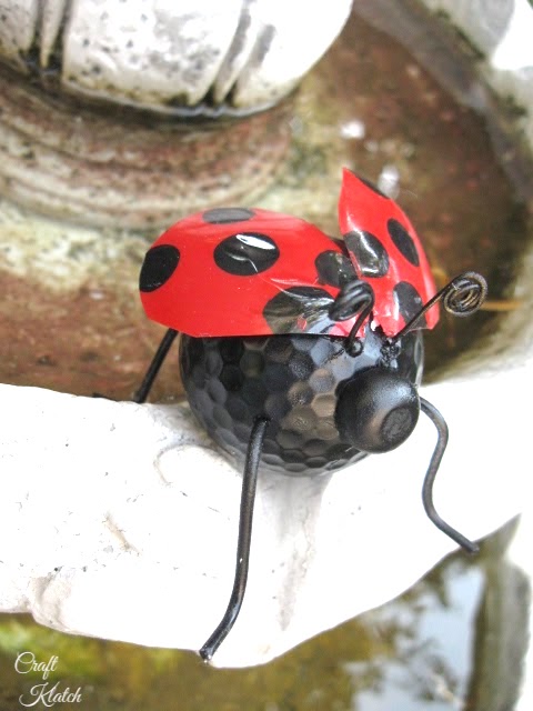 Finished ladybug craft on edge of fountain