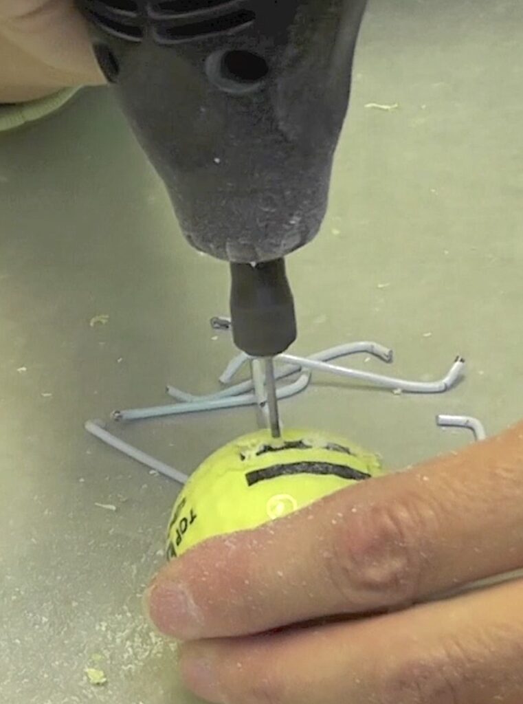 Drill hole into golf ball