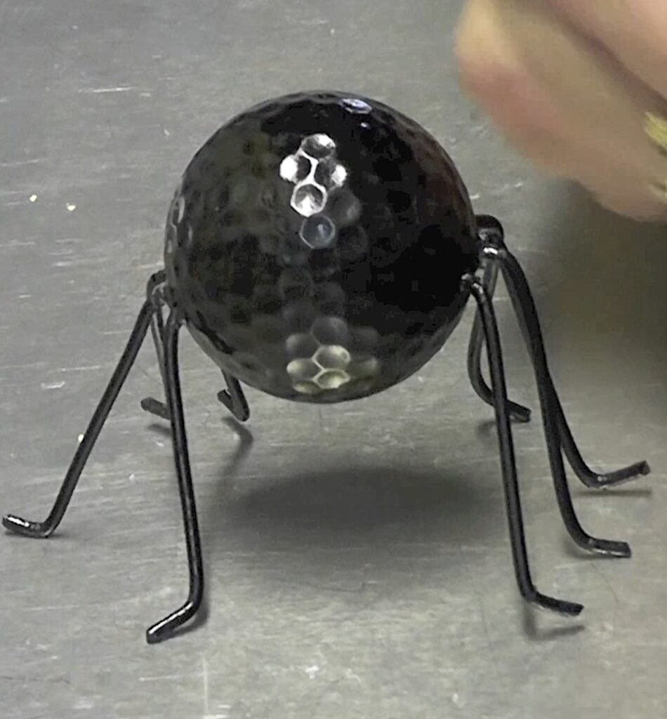 Golf ball spider painted black