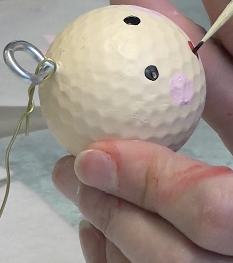 Add features to fun Santa golf ball face with a skewer stick