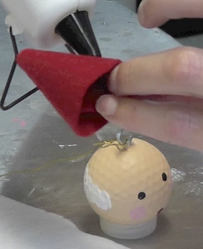 Glue a piece of red felt into a cone