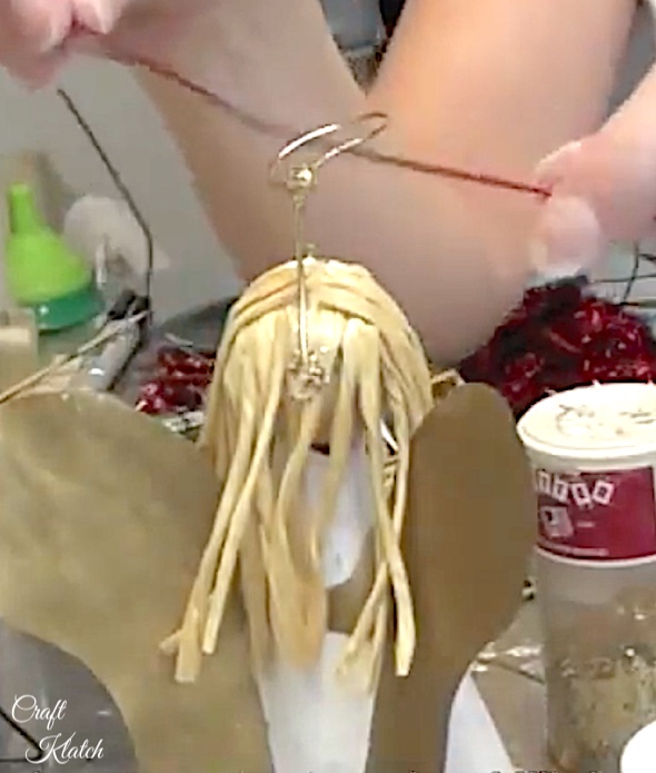 Glue wire halo into angel tree topper hair