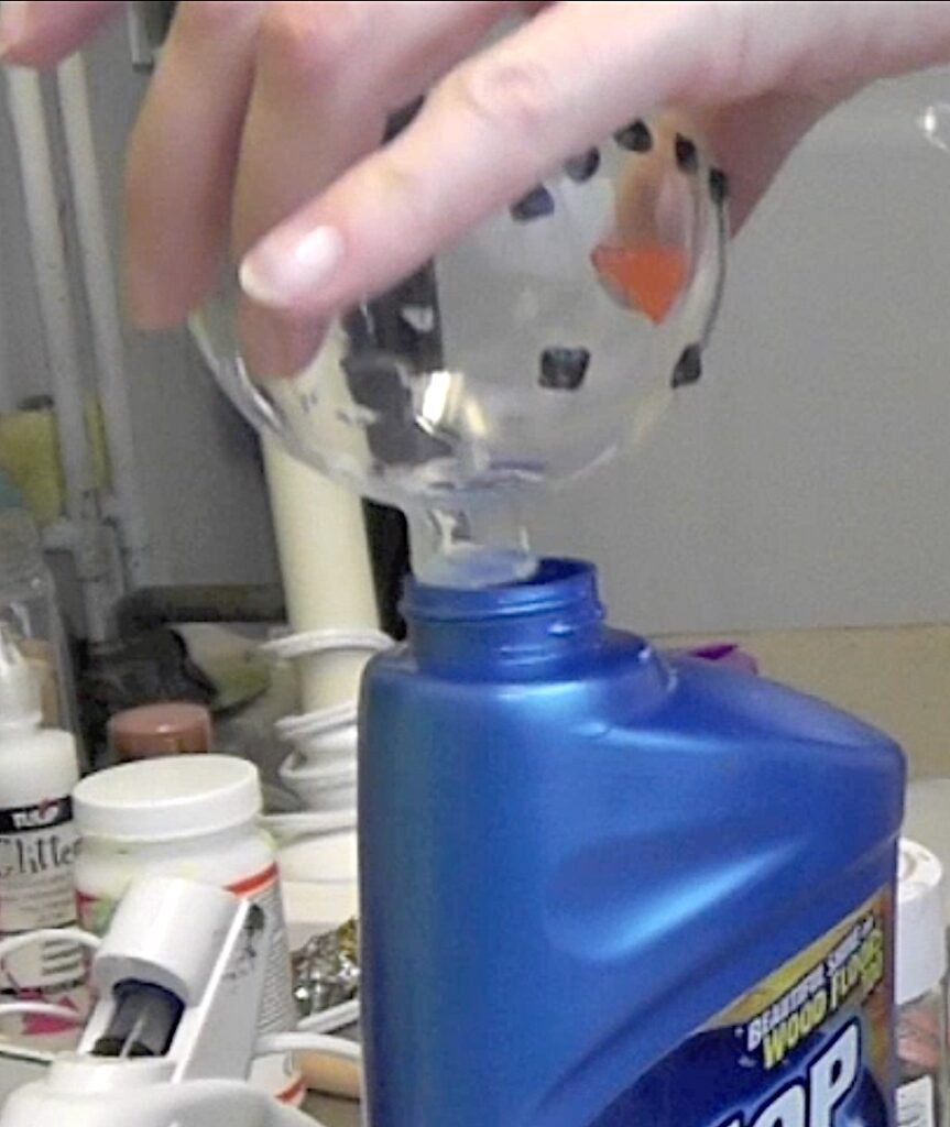 Pour excess floor wax into the bottle