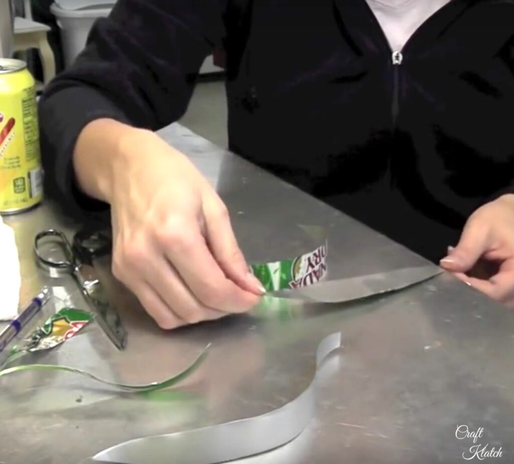 Straightening strips of aluminum can