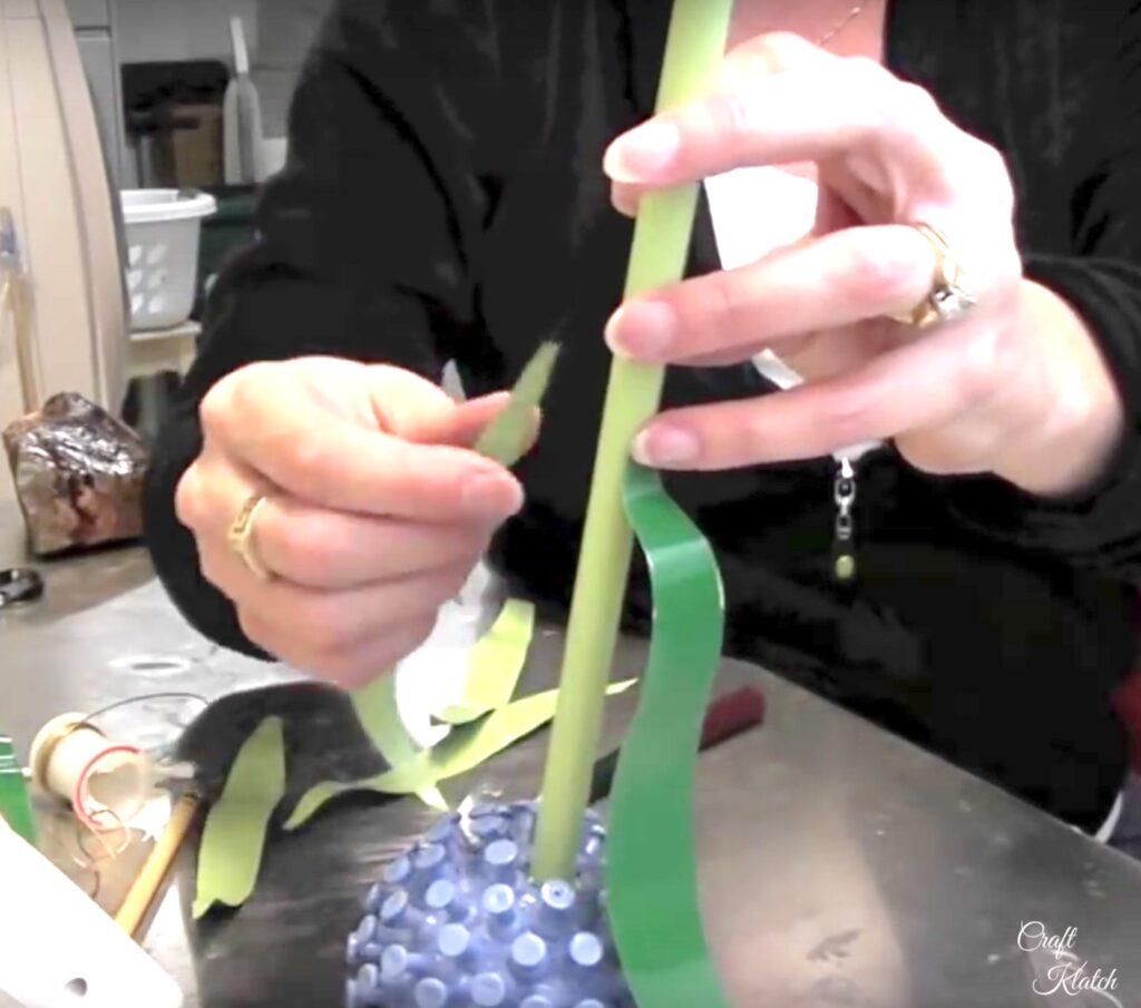 Glue aluminum can leaves onto stem