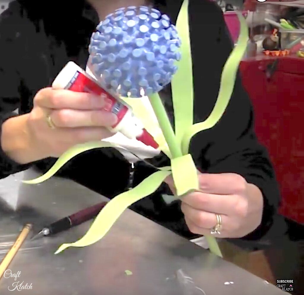 Glue leaves onto recycled flower garden art