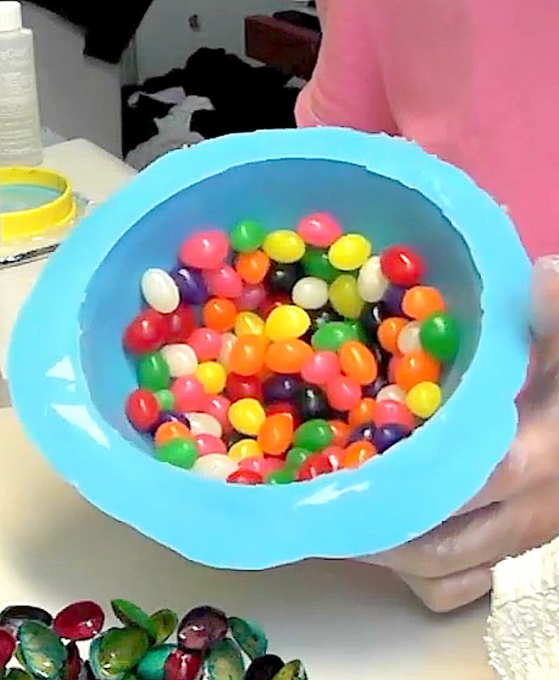 Blue silicone mold full of colorful jellybeans