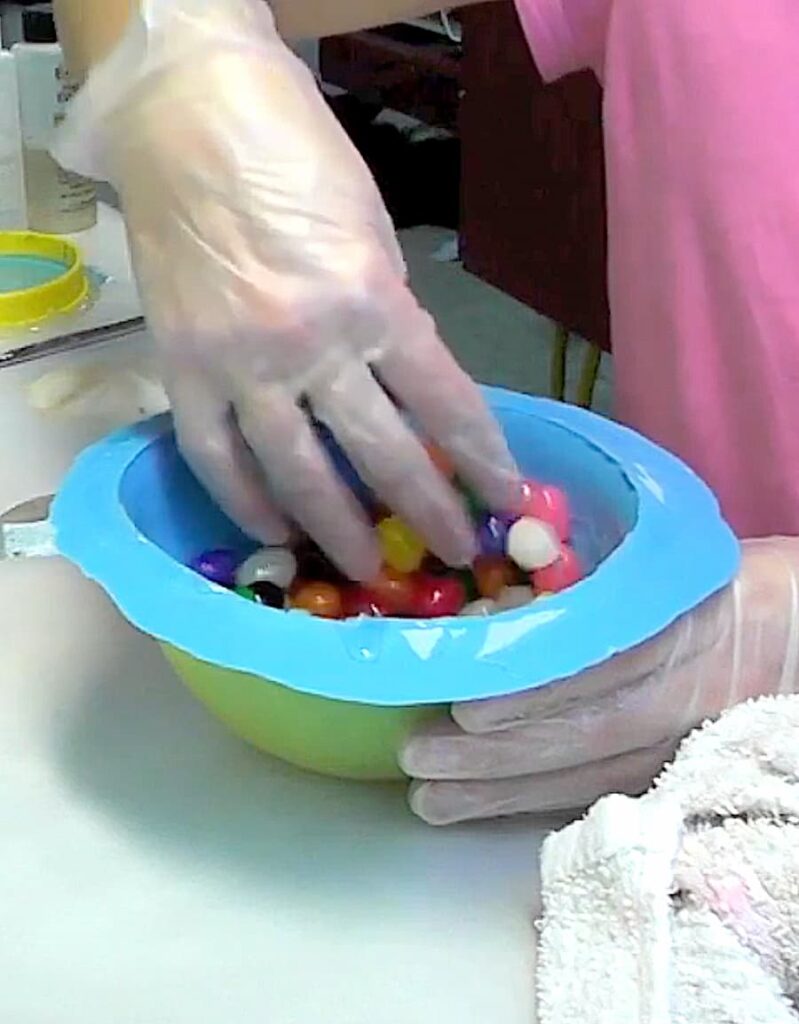 Coating the Easter candy jellybeans with resin