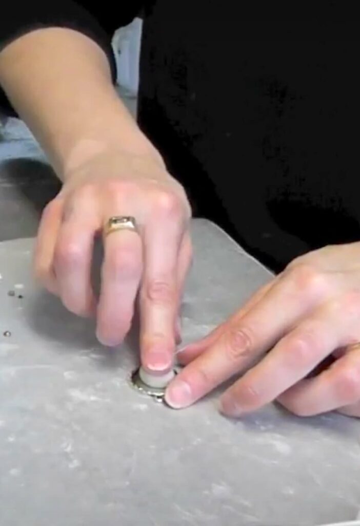Pressing the epoxy clay into the bezel