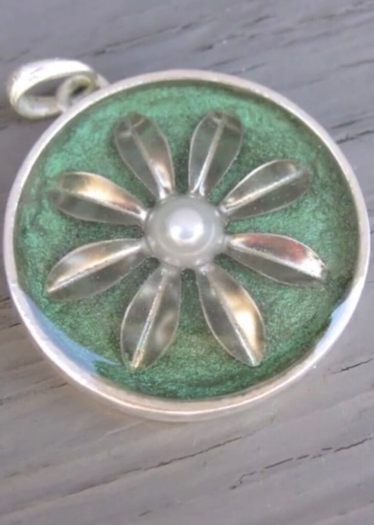 How to Make Metal Jewelry Easy Flower Pendant DIY with a green background and a pearl center