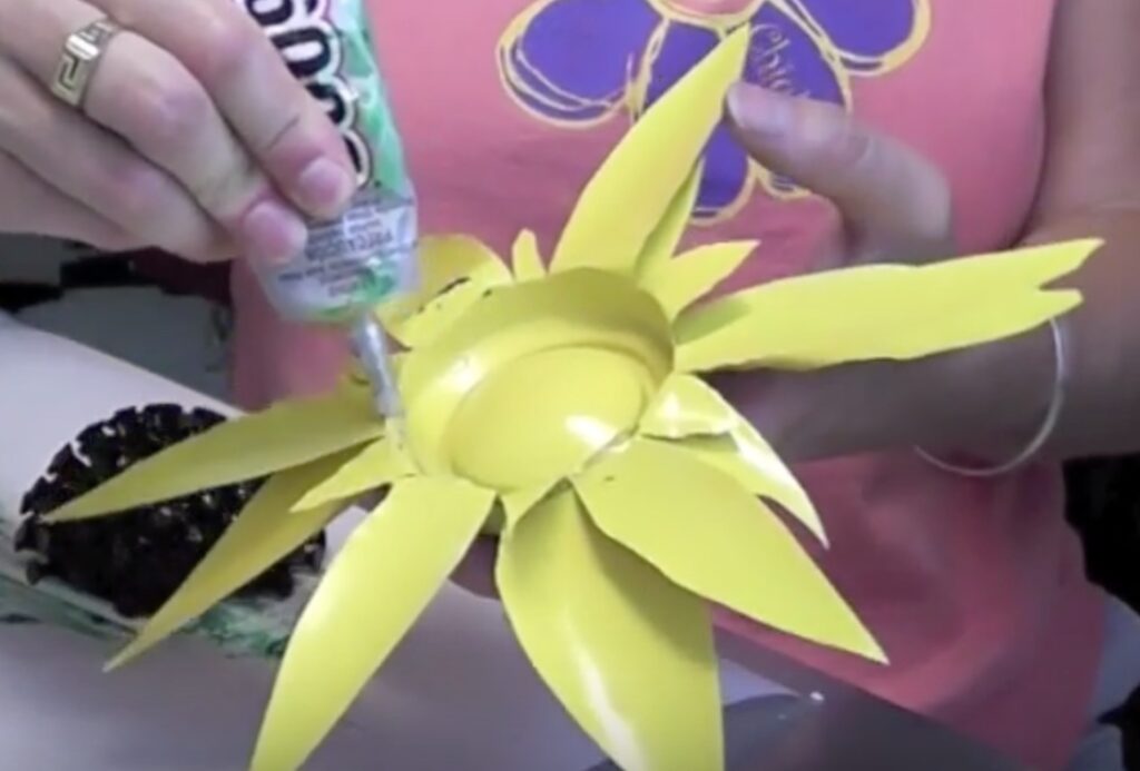 Squeeze glue into the inside of the glued together flowers