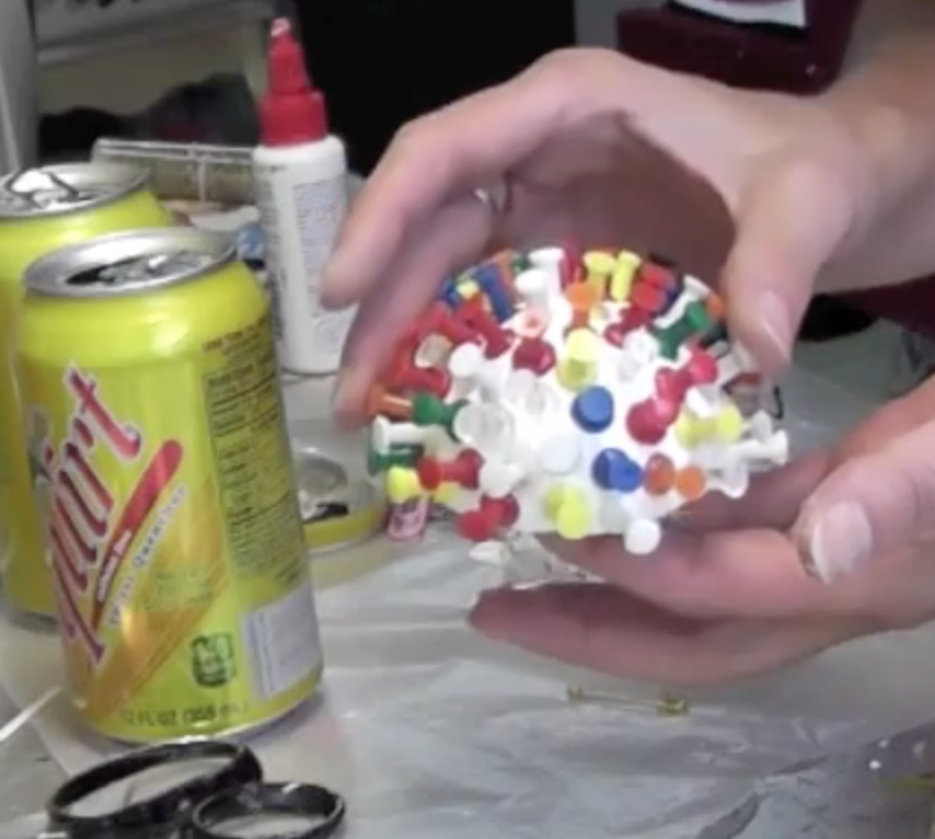 Half styrofoam ball covered in colorful pushpins