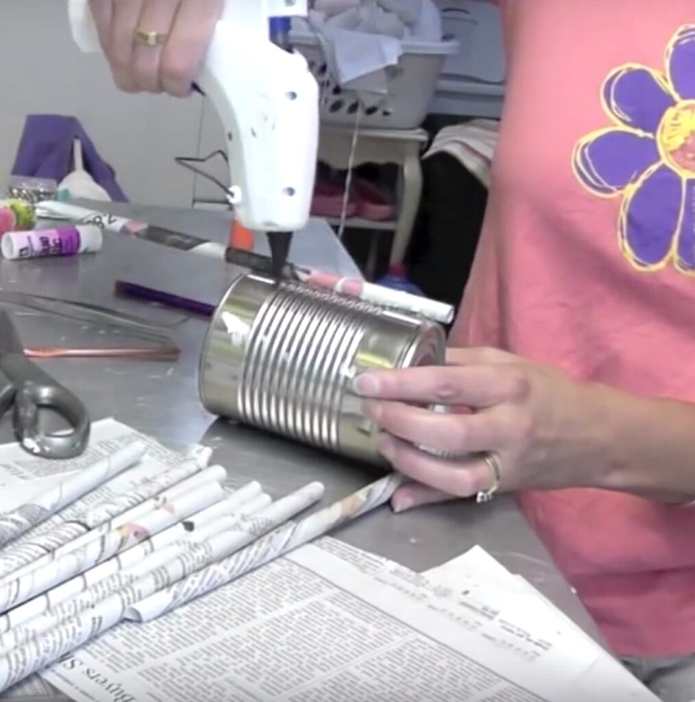 Keep adding glue and newspaper rolls onto the aluminum can