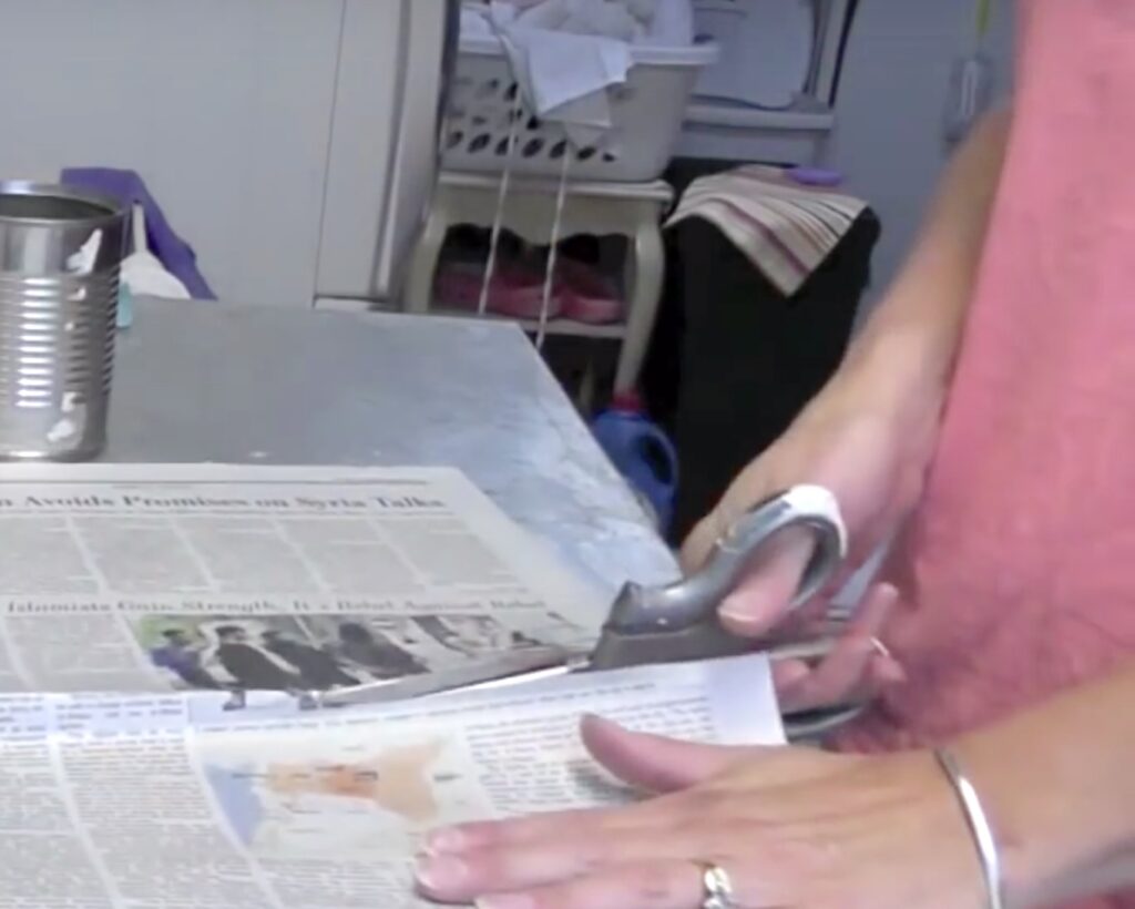 Cut newspapers with scissors