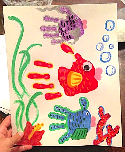 Handprint fish art three fish - a purple, red and blue with coral bubbles and seaweed