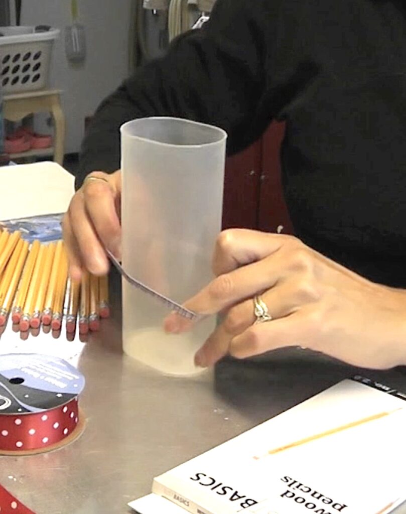 Back to School pencil vase putting rubberband around container for back to school pencil vase