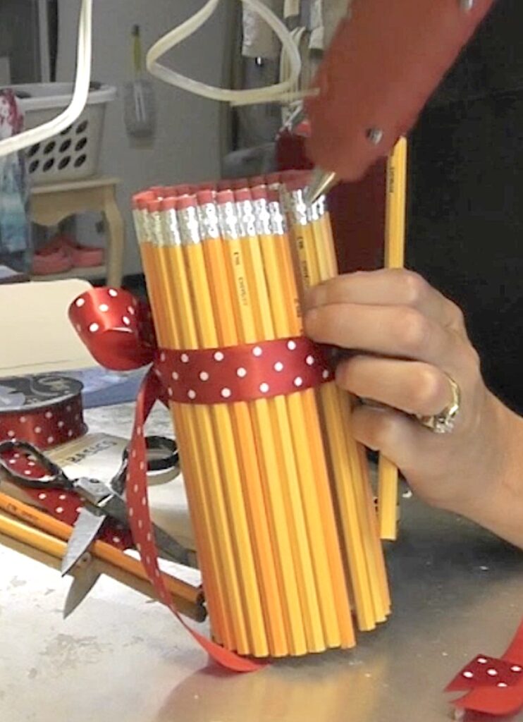 Hot glue pencils on to the vase