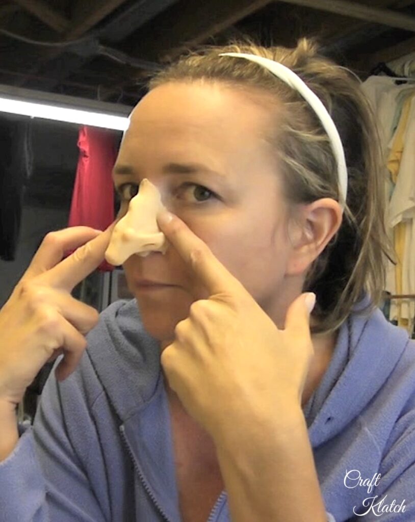 Hold witch makeup nose to your face to start your Halloween costume