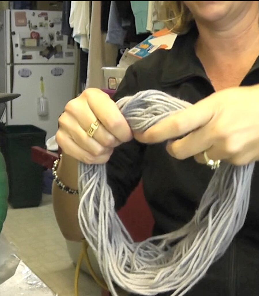 Make a loop of gray yarn