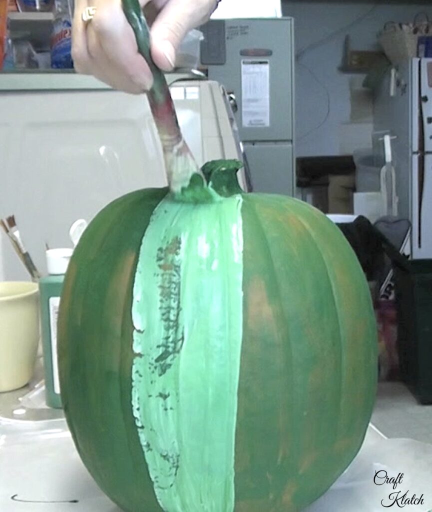 Paint pumpkin with a white and green color mixture to make it more of a Frankenstein pumpkin decorating no carve