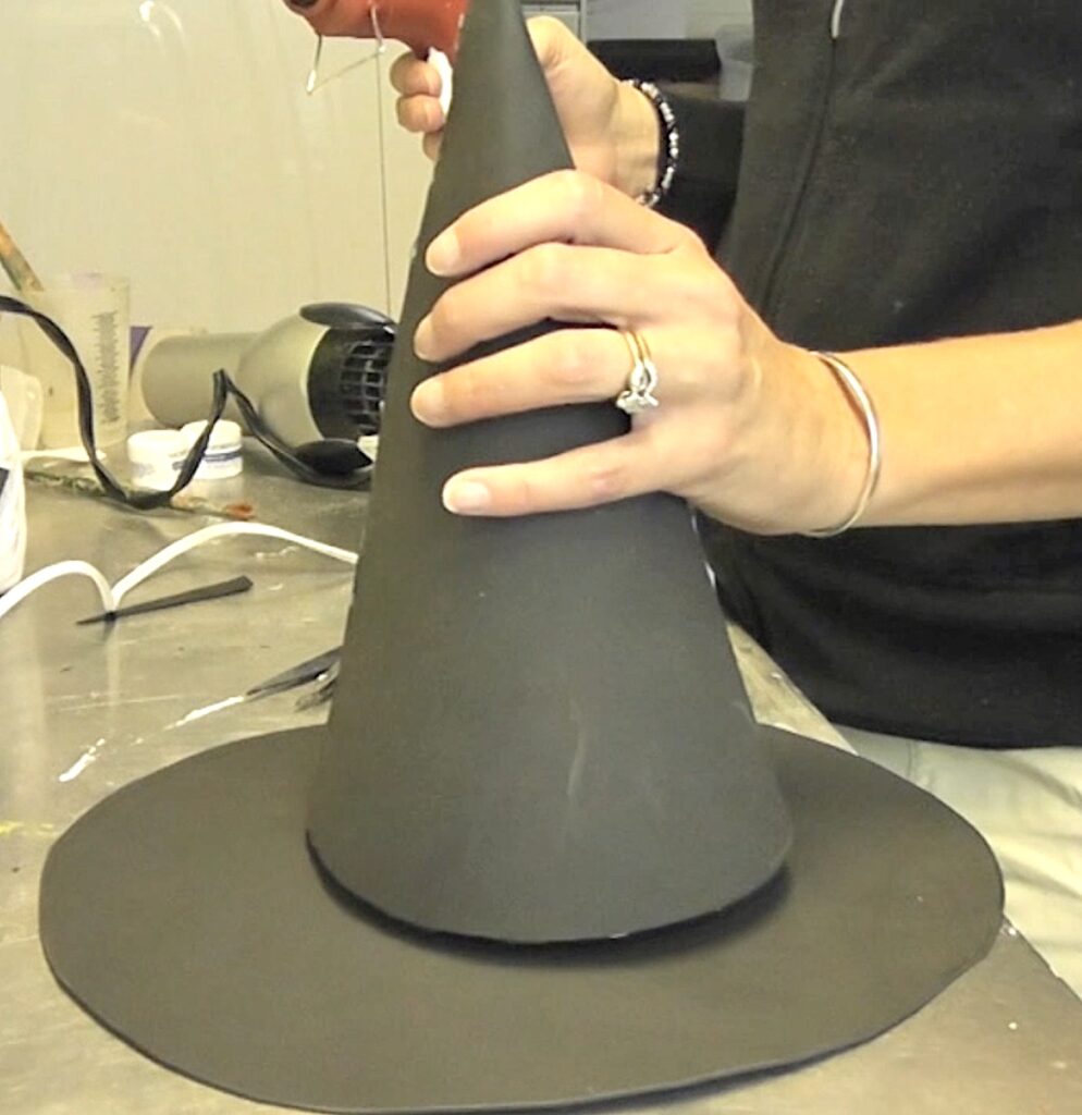 Glue cone onto the top of the witch hat brim