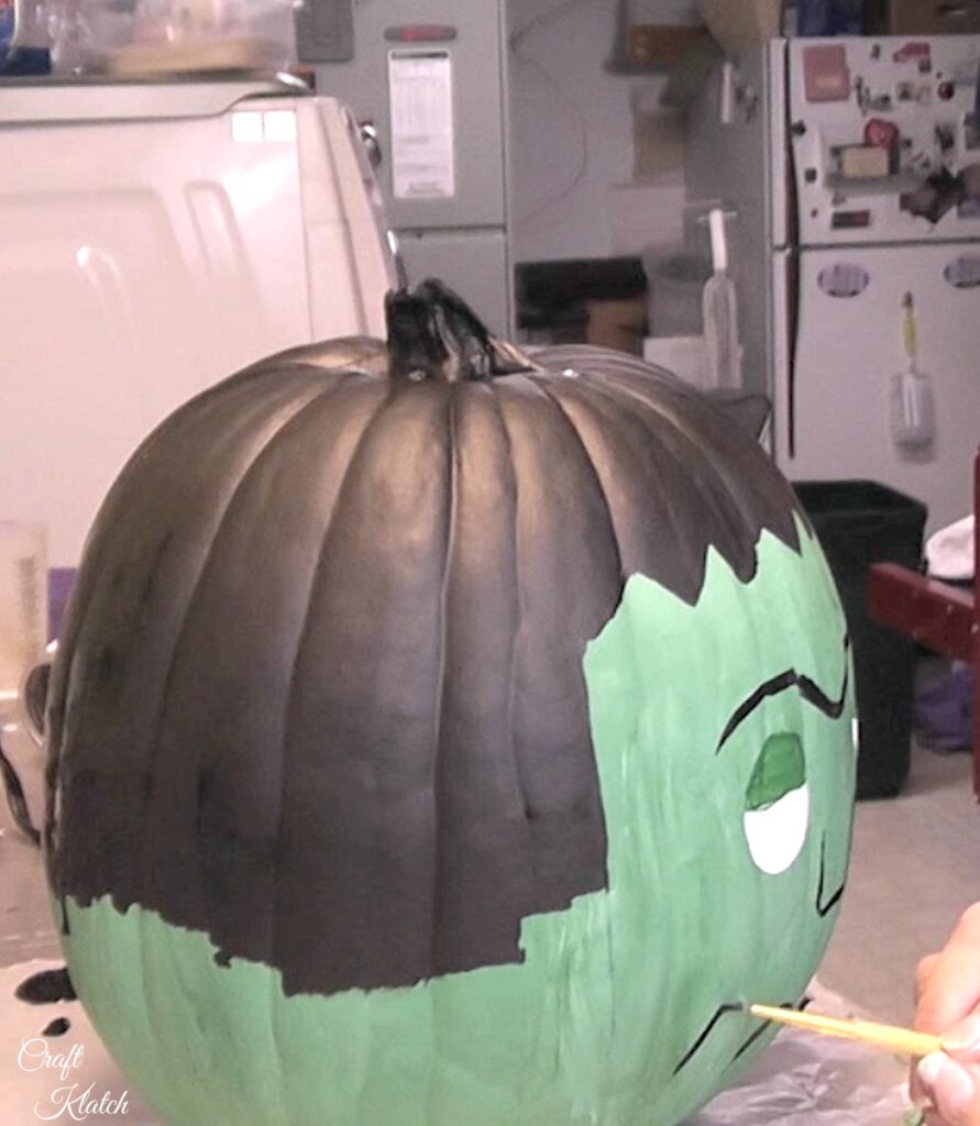 Paint Frankentein features onto the pumpkin