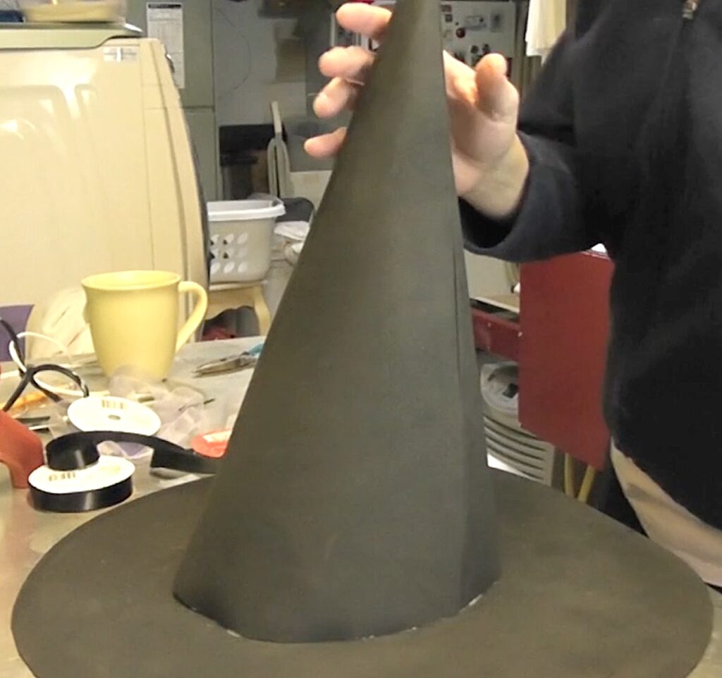 Glue to cone to the brim of the witch hat