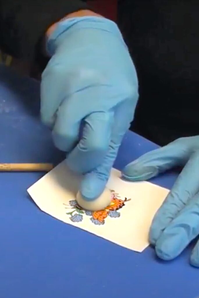 Squishing the epoxy clay ball to the image to transfer an image to clay