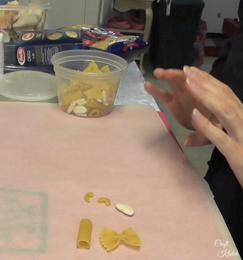 Supplies for Christmas angel noodle crafts. Gather dried pasta and dried lima beans