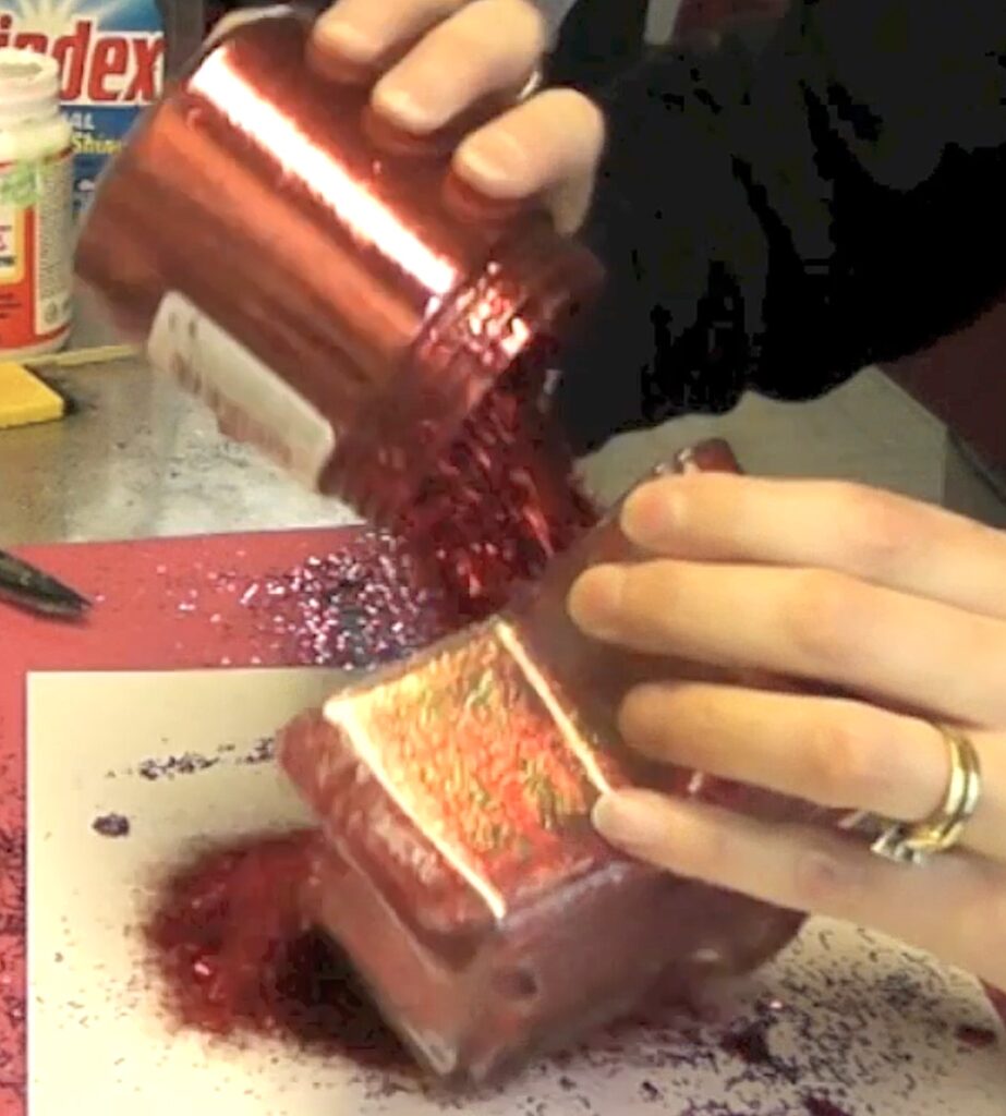 Brush Mod Podge on the inside of the candy dish and pour coarse red glitter on it