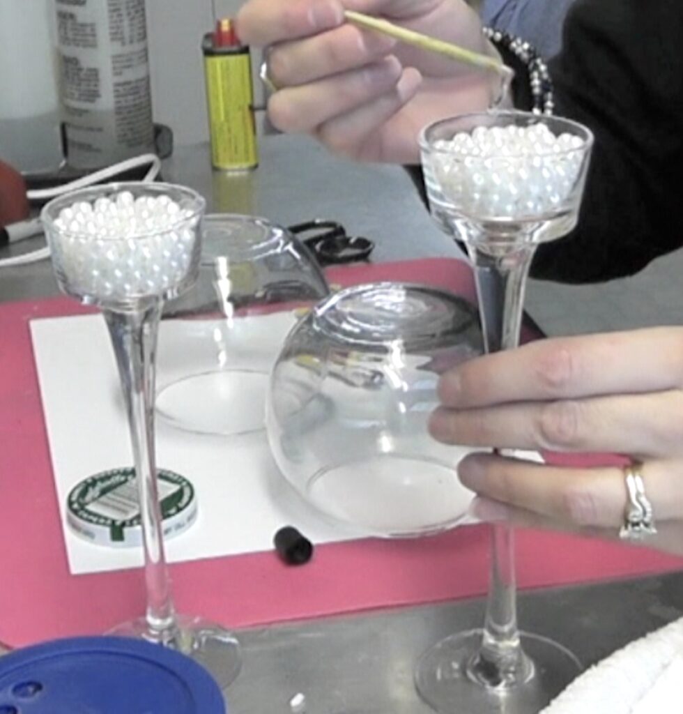 adding glue to edge of glass candle holder