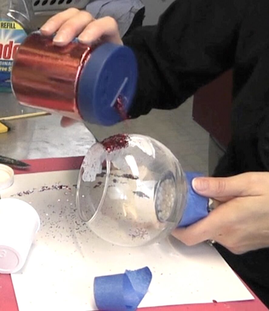 Sprinkle red glitter on the glass candle holder diy