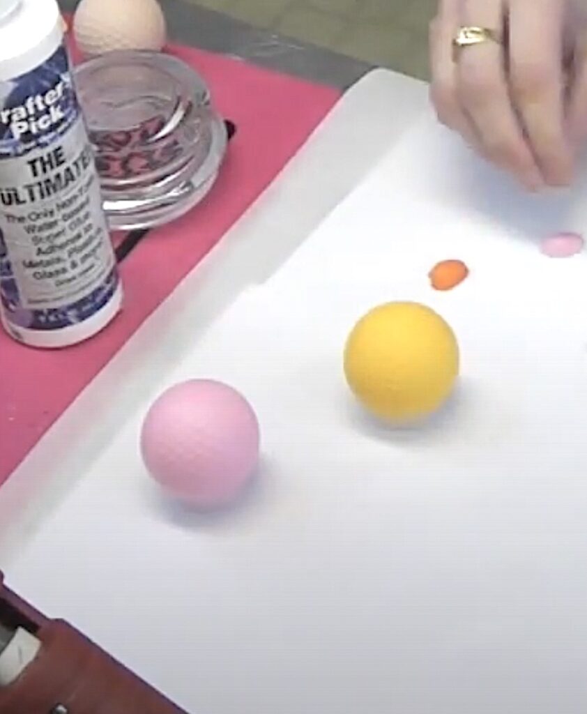 Painted golf balls pink and yellow