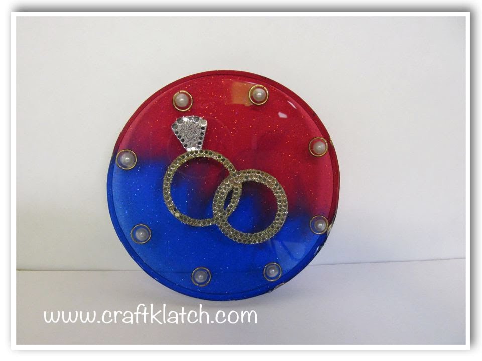 red and blue wedding coaster with set of rings