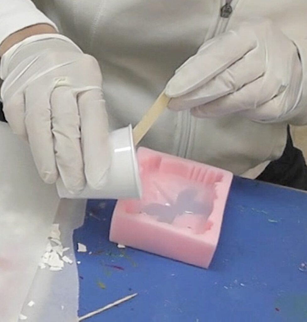 Pour white resin into the mold to create the background for the sea glass dragonfly