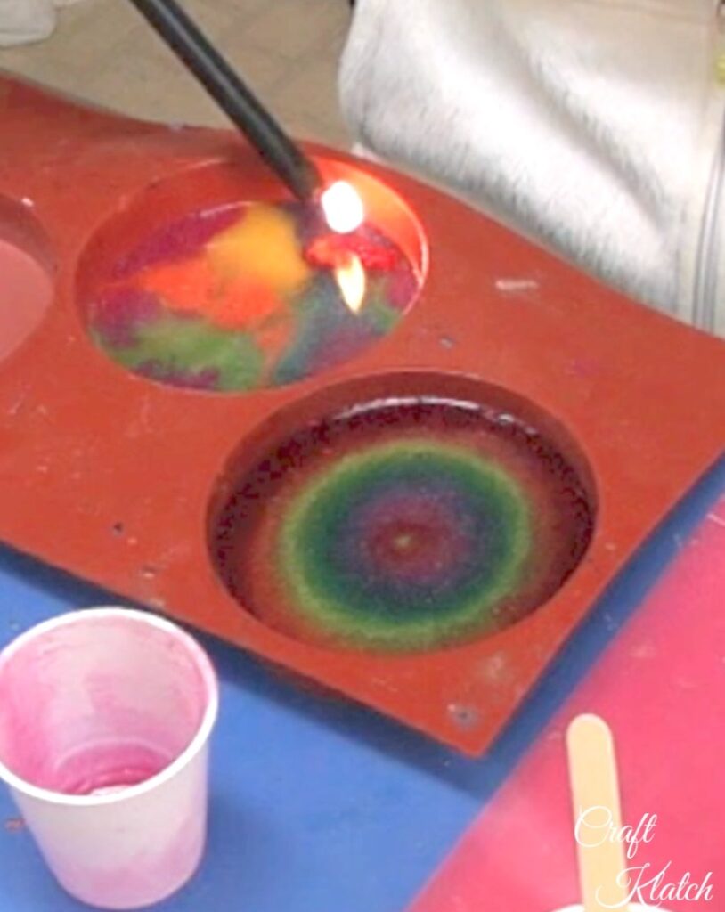 Pop bubbles on rainbow coasters with lighter