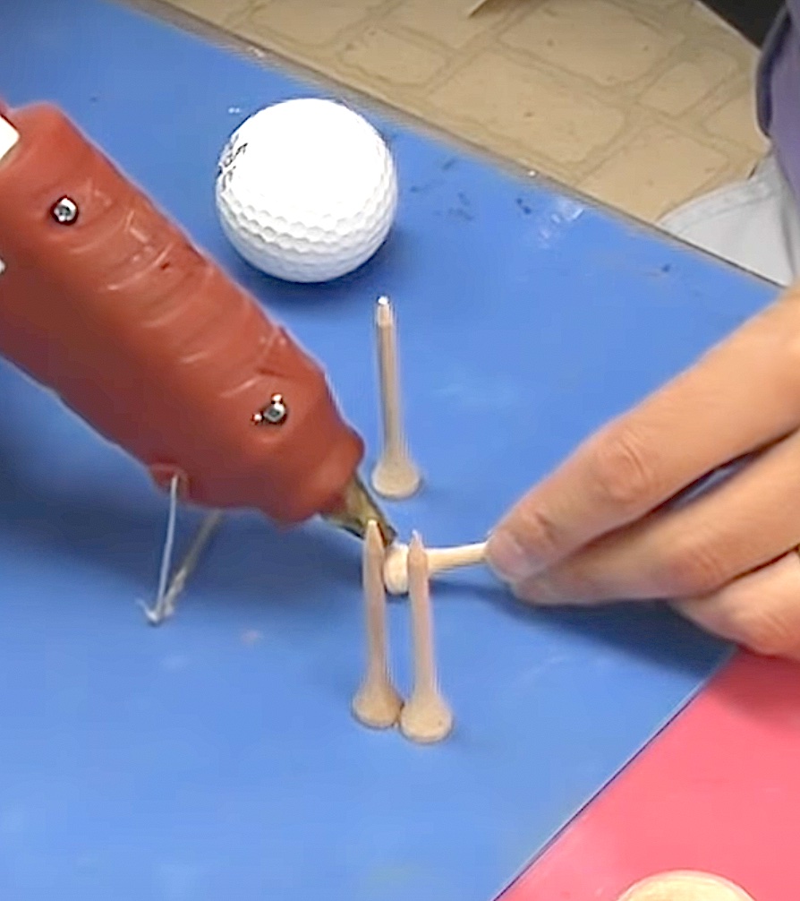 Glue four golf tees together