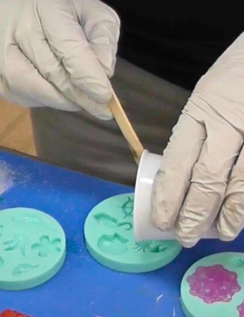 Pouring resin into the silicone mold for the crab craft