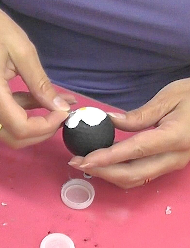 Glue on google eyes to the cute penguin golf ball