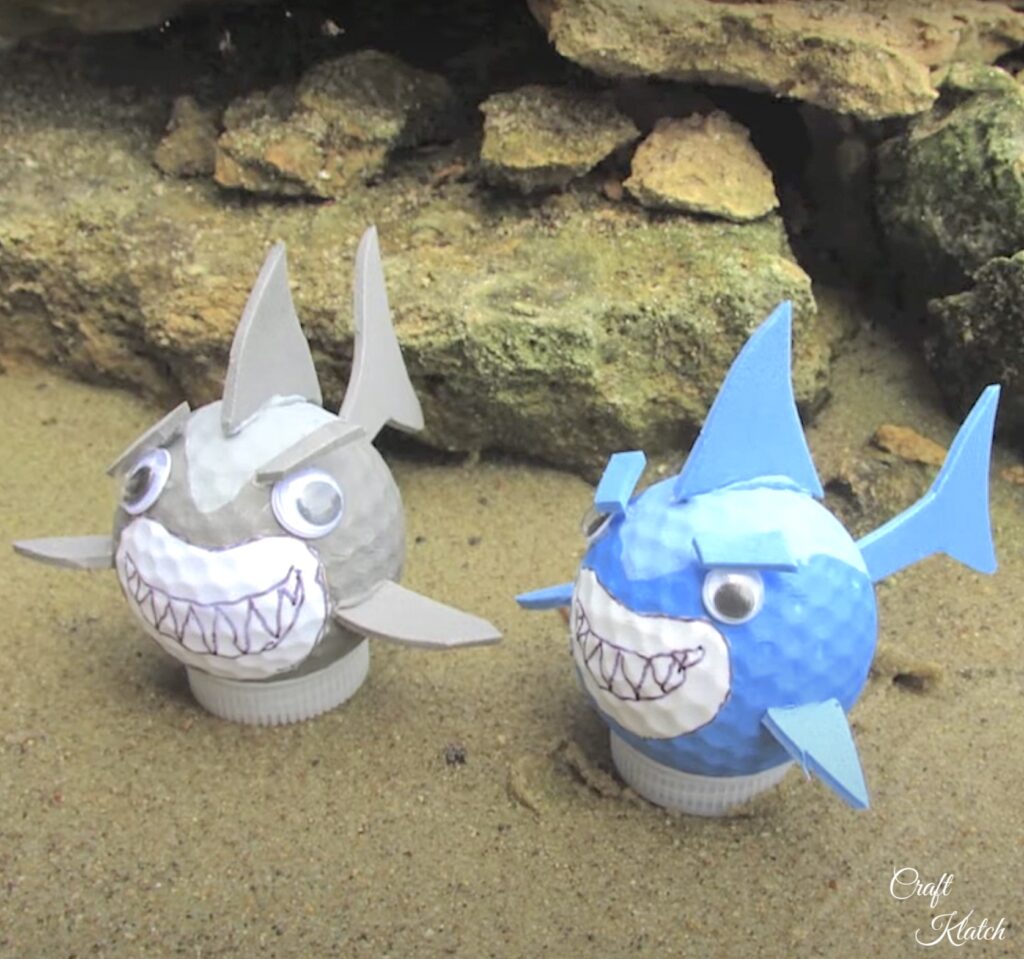 Golf ball sharks sitting in sand craft diy