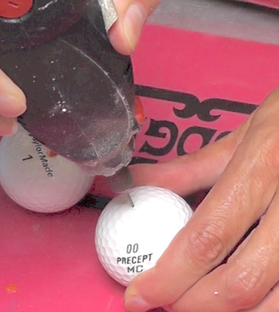 Drill holes in golf balls