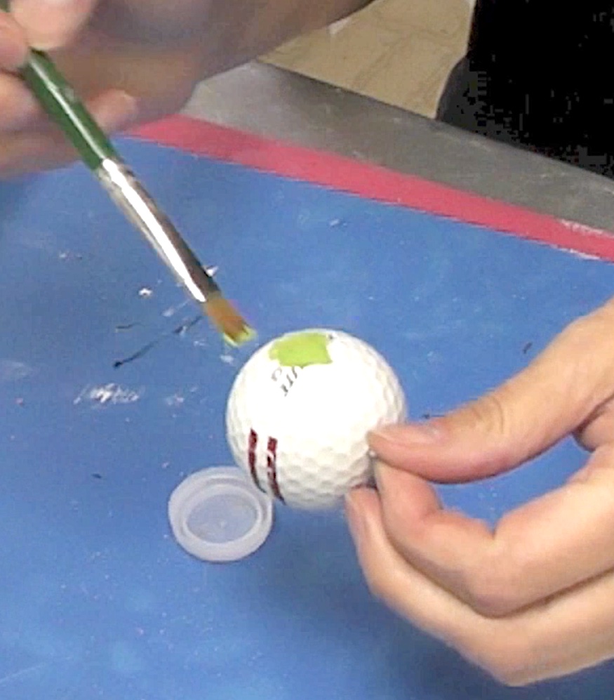 Paint the golf ball and nose green