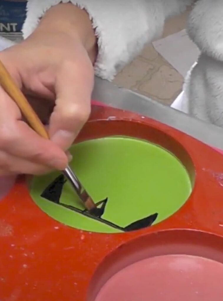 Painting Frankensteins hair on the resin coaster