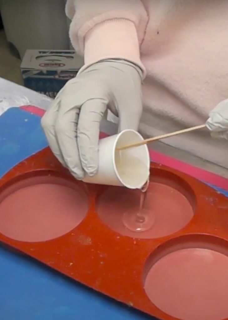 Pouring resin into a coaster mold